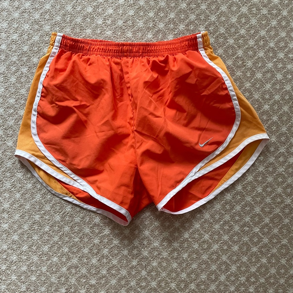 Orange Nike running shorts